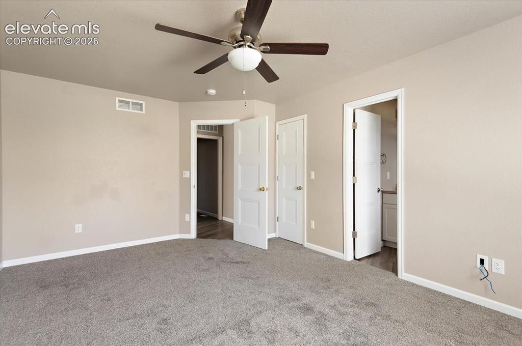 Image 11 of 21: Spacious room featuring neutral painted walls, gray carpet flooring, a ceil