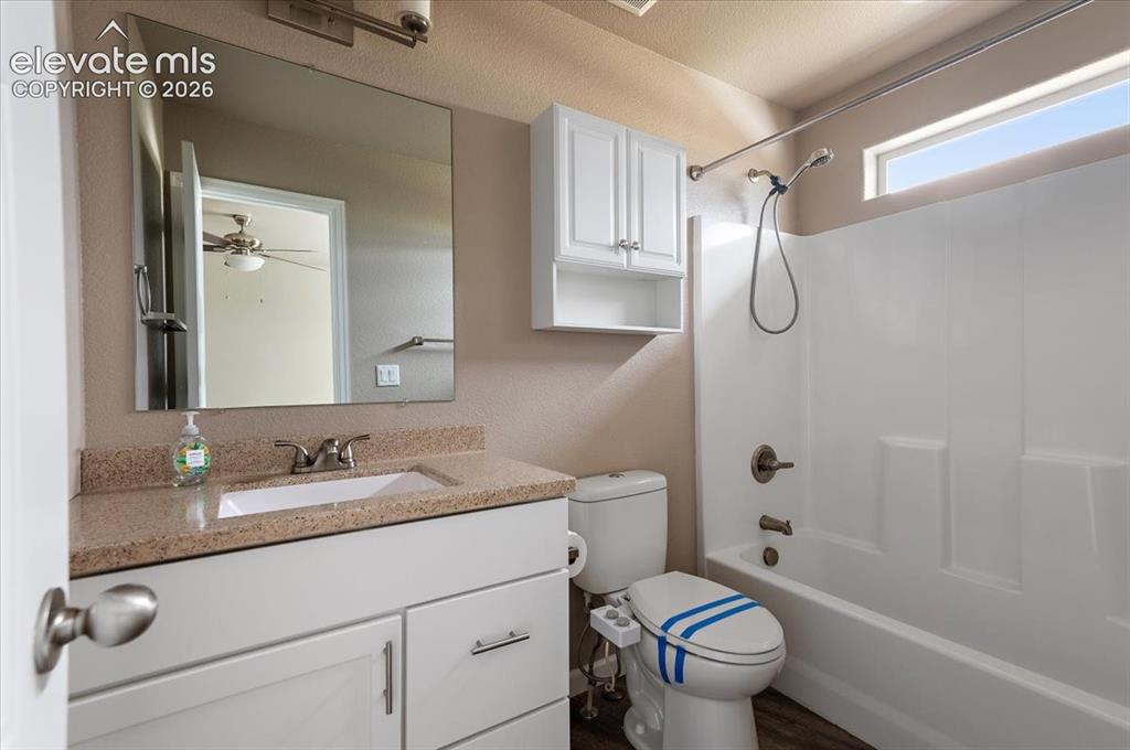 Image 13 of 21: Bathroom featuring a white vanity with a light-toned countertop, an integra