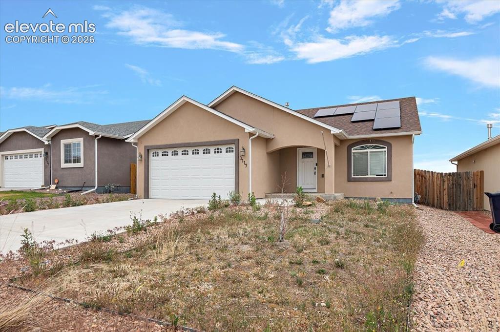 Image 18 of 21: Single-story residence featuring a stucco exterior and an attached garage w