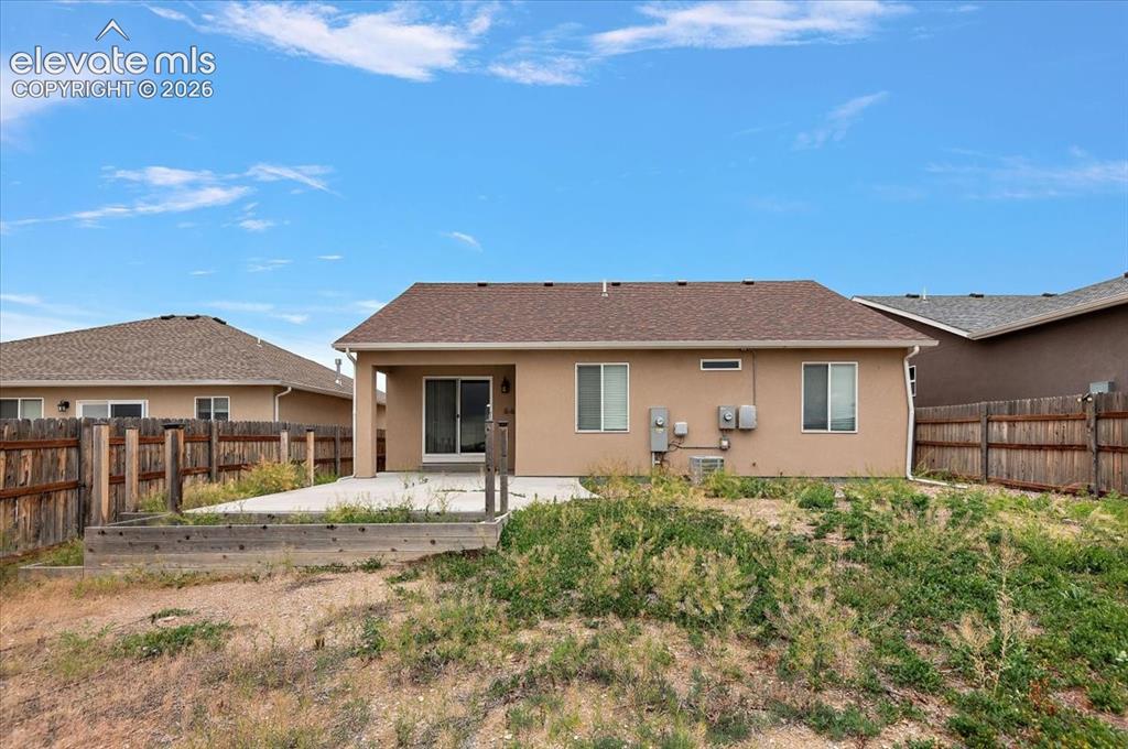 Image 20 of 21: Rear exterior with stucco siding and a covered patio