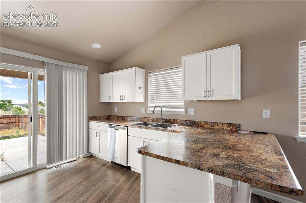 Image 4 of 21: Kitchen featuring white cabinetry, a double basin sink, and ample counter s