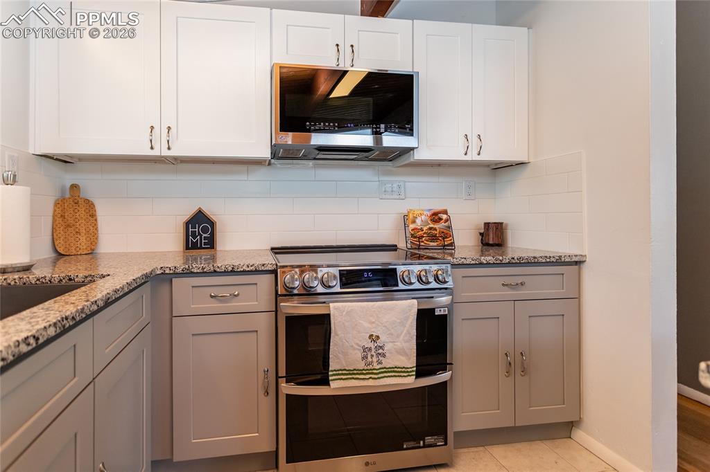 Image 14 of 36: Beautiful new gray and white cabinets.