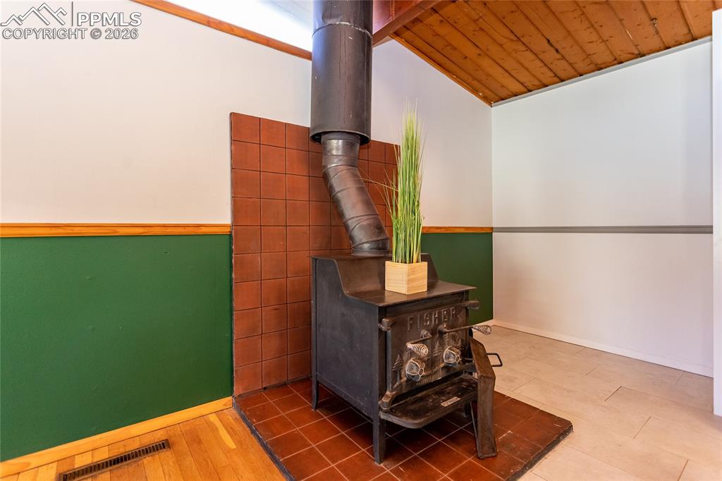 Image 20 of 36: Wood burning fireplace and small breakfast nook.