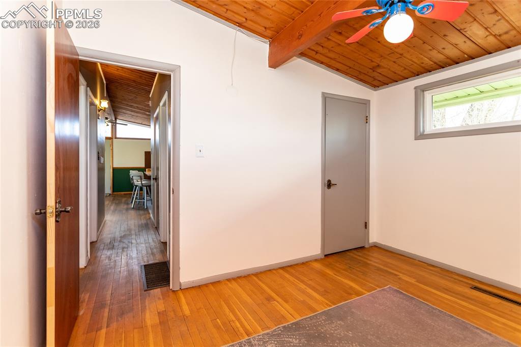 Image 29 of 36: 2nd bedroom looking out to hallway.