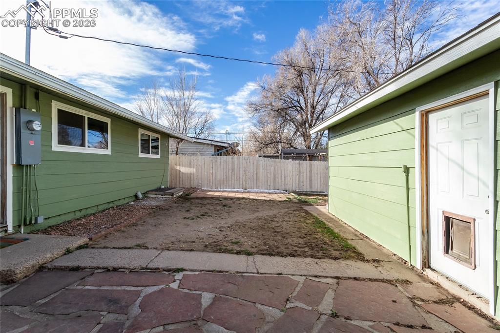 Image 31 of 36: Patio, yard, all enclosed with new fencing.