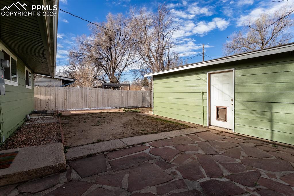 Image 32 of 36: Side of house to side of garage.