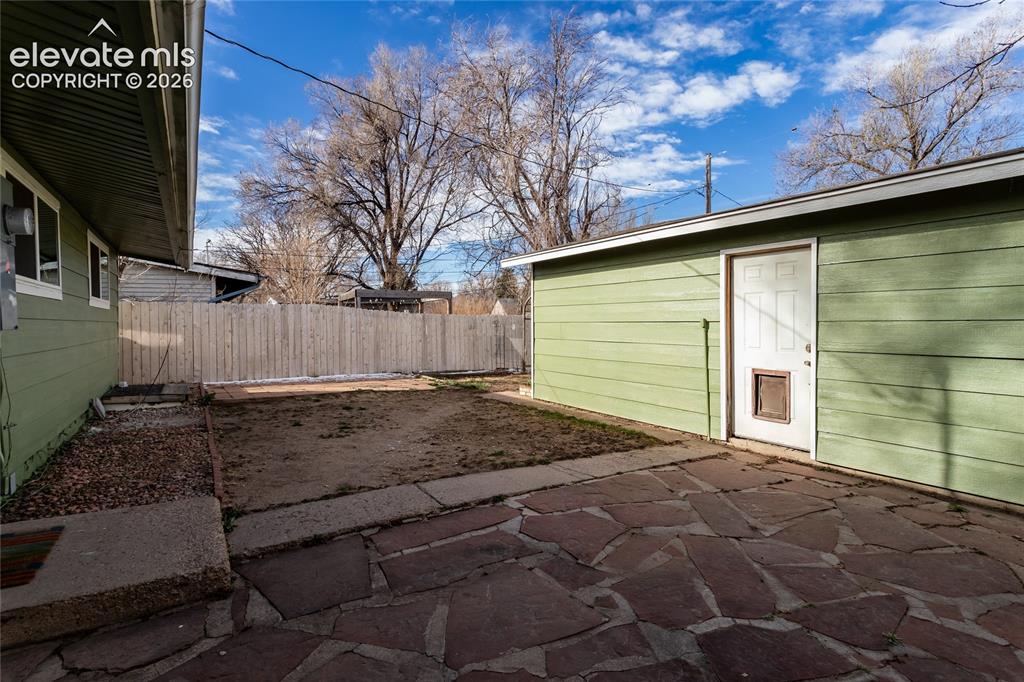 Image 36 of 40: Side of house to side of garage.