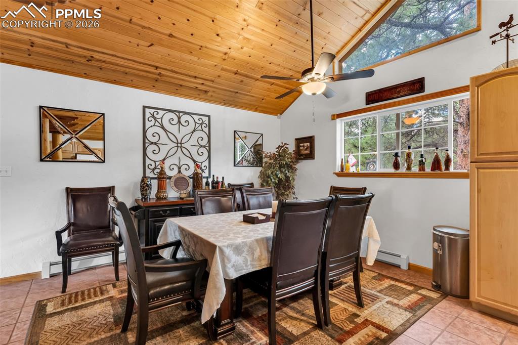 Image 10 of 49: Tile floor, ceiling fan, and plenty of natural light in dining area next to