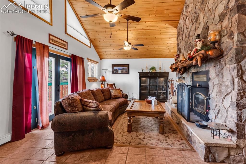 Image 19 of 49: Custom live edge fireplace mantel and wood burning fireplace