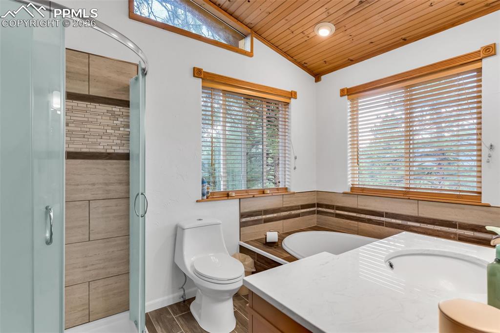 Image 23 of 49: Primary bathroom with high ceilings and soaking tub