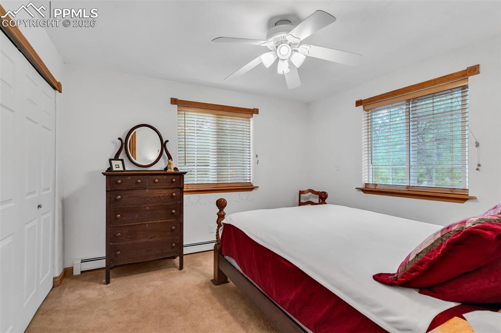 Image 29 of 49: Third Main level bedroom with electric baseboard heating from solar panels