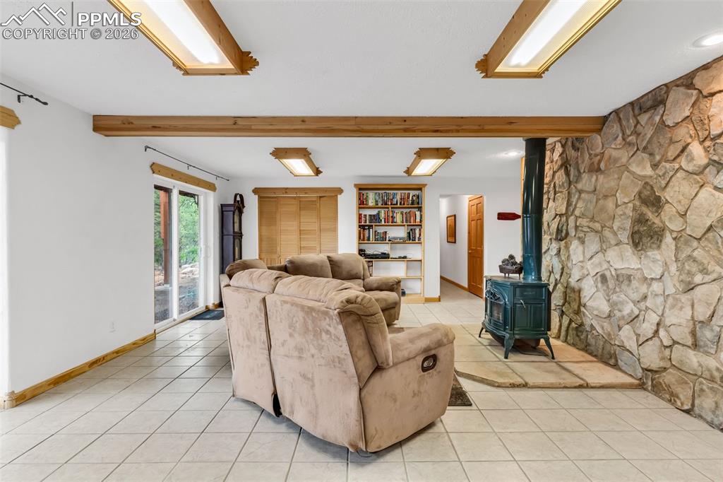 Image 32 of 49: Cozy fireplace and large laundry closet with laundry sink