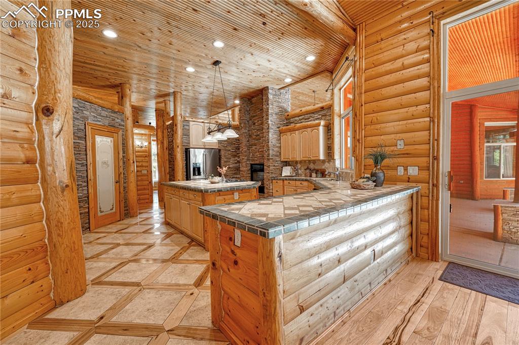 Image 15 of 50: Custom tile countertops add color and character to the space
