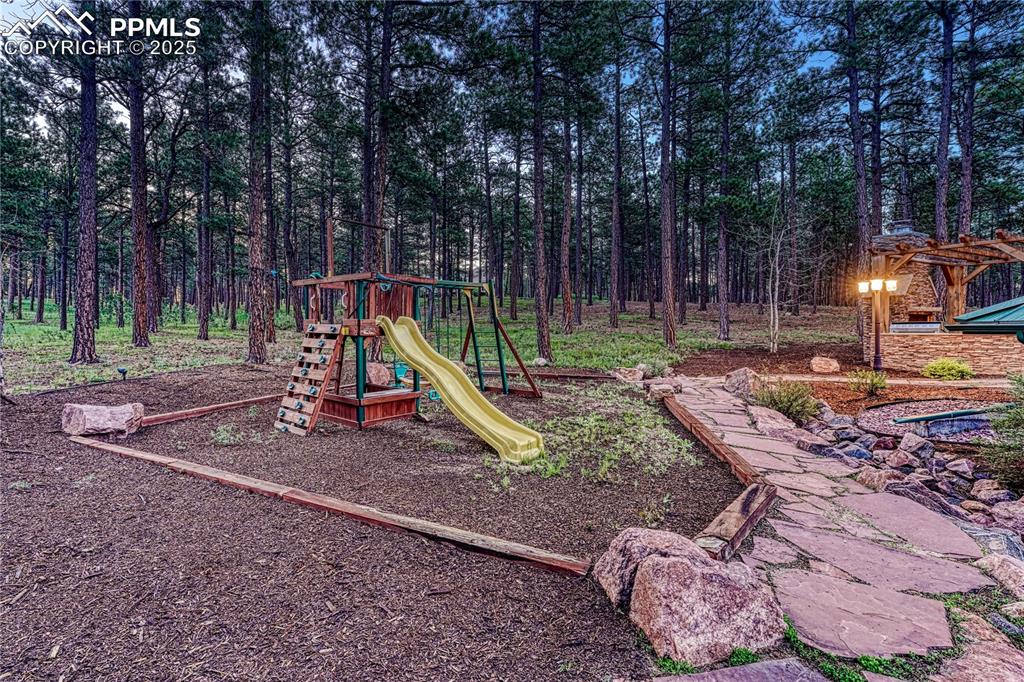 Image 44 of 50: Playset in the side yard