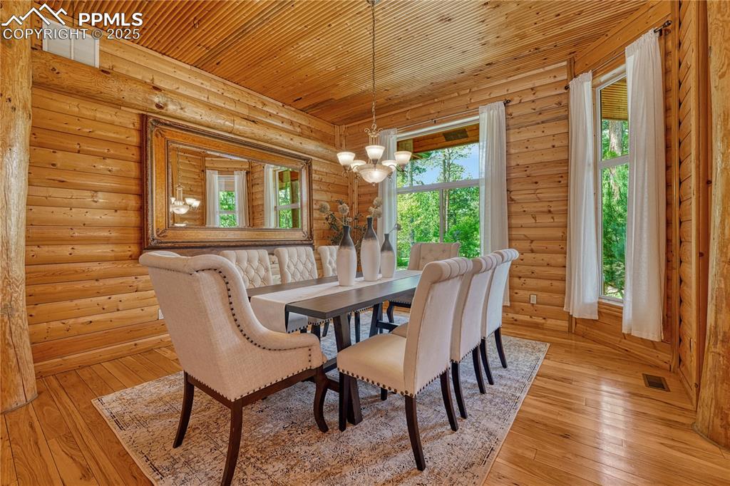 Image 8 of 50: Off the entry is a formal dining room surrounded by full tree columns