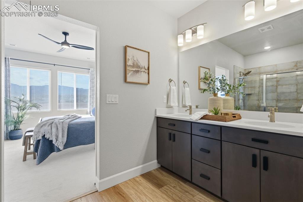 Image 22 of 47: Ensuite bathroom with double vanity, upgraded shower and wood laminate floo