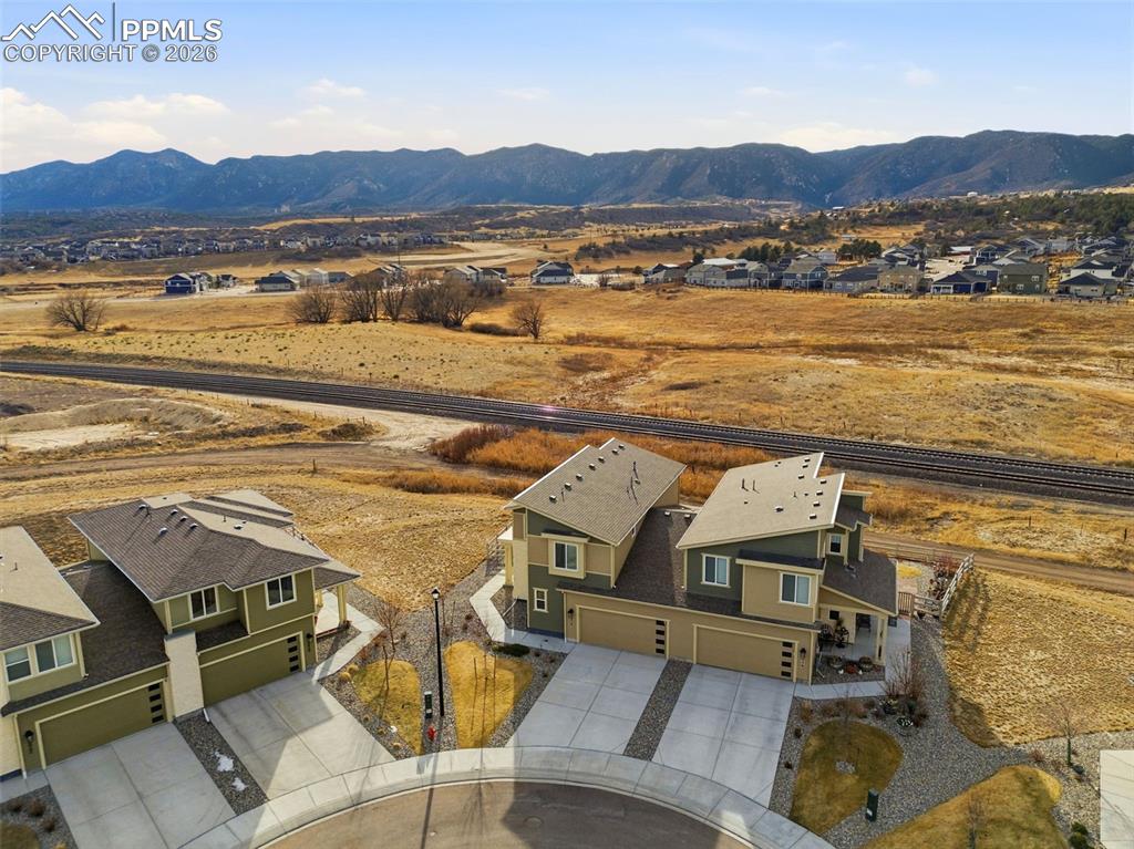 Image 45 of 47: Aerial perspective of suburban area featuring a mountainous background