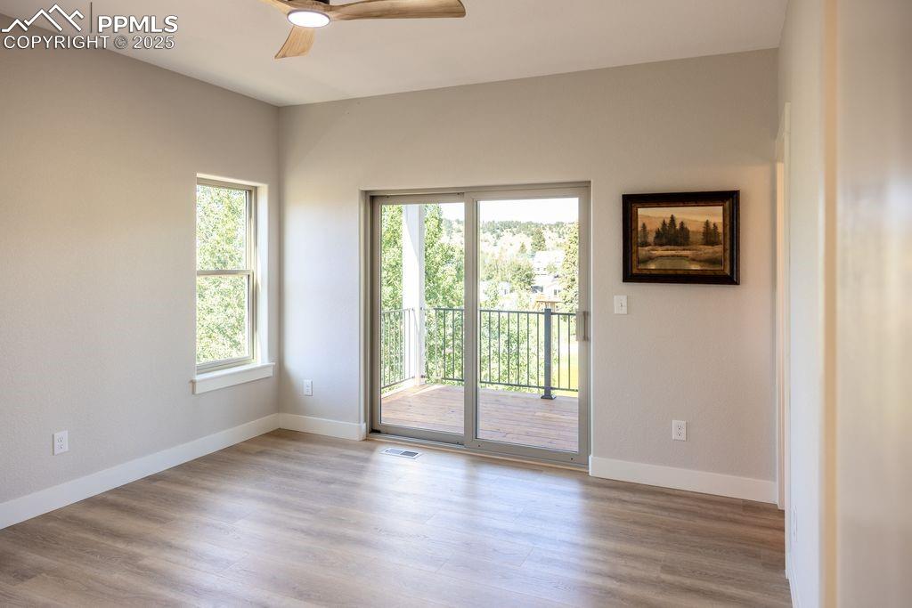 Image 18 of 21: Primary bedroom w/walkout slider, leads to 8