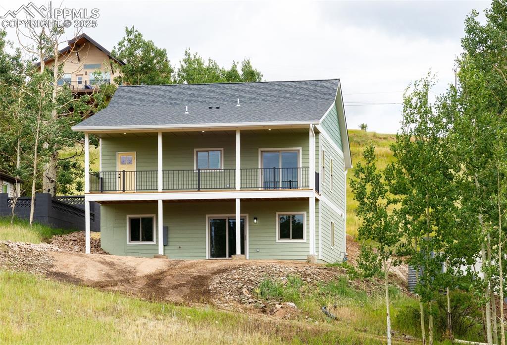 Image 3 of 21: Back of the home, featuring a covered, redwood deck 8