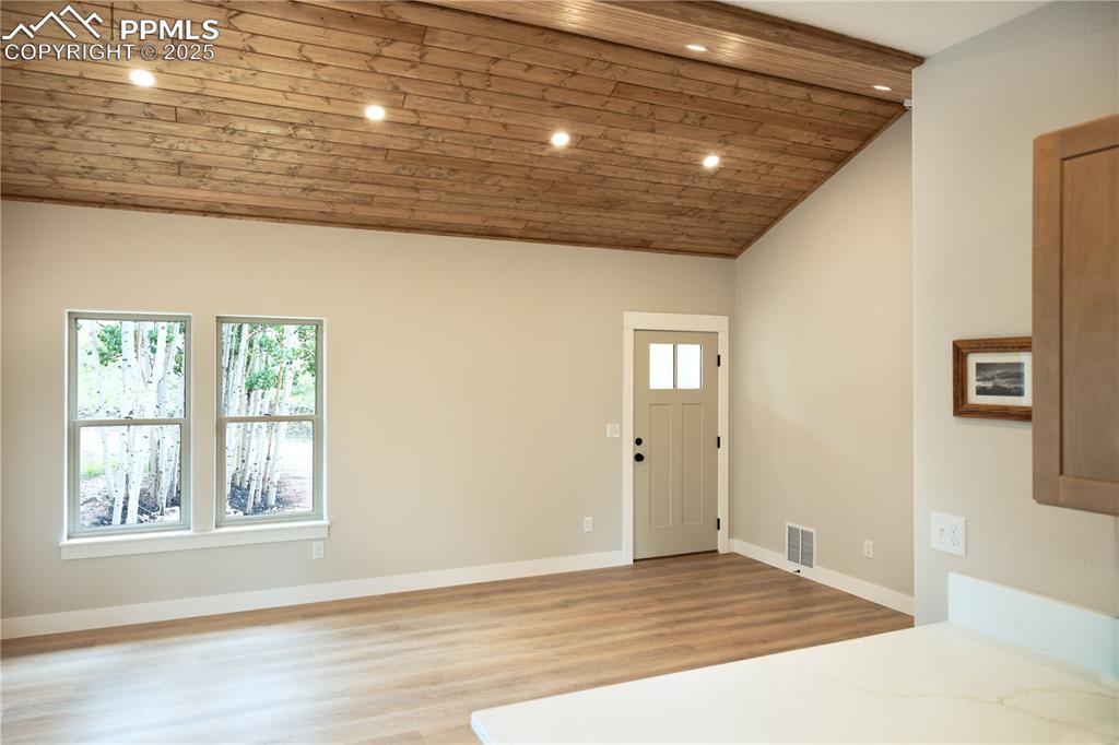 Image 4 of 21: Foyer with vaulted ceiling, plenty of natural light, wooden ceiling, LV flo
