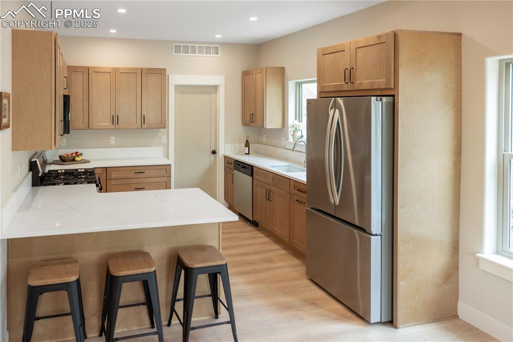Image 8 of 21: Large walk-in pantry/laundry room, light wood-LV flooring, and recessed lig