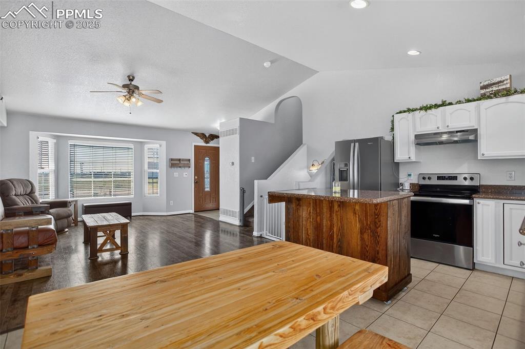 Image 13 of 50: with granite countertops and custom rolling island