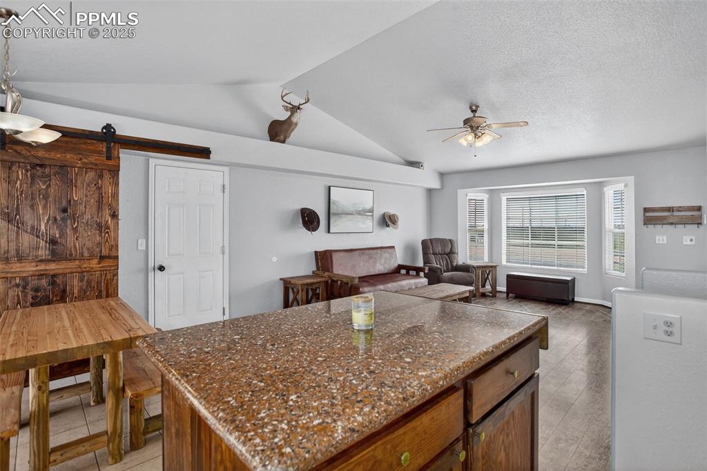 Image 17 of 50: with granite countertops and custom rolling island