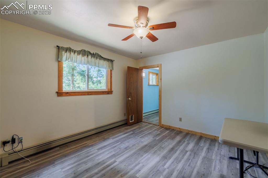 Image 18 of 32: Third main level bedroom with attached bathroom 