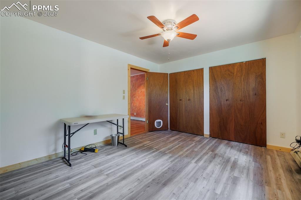 Image 19 of 32: Unfurnished bedroom with wood finished floors, two closets, and a ceiling f