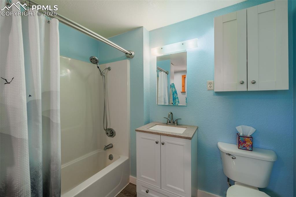Image 20 of 32: Bathroom featuring shower / tub combo and vanity