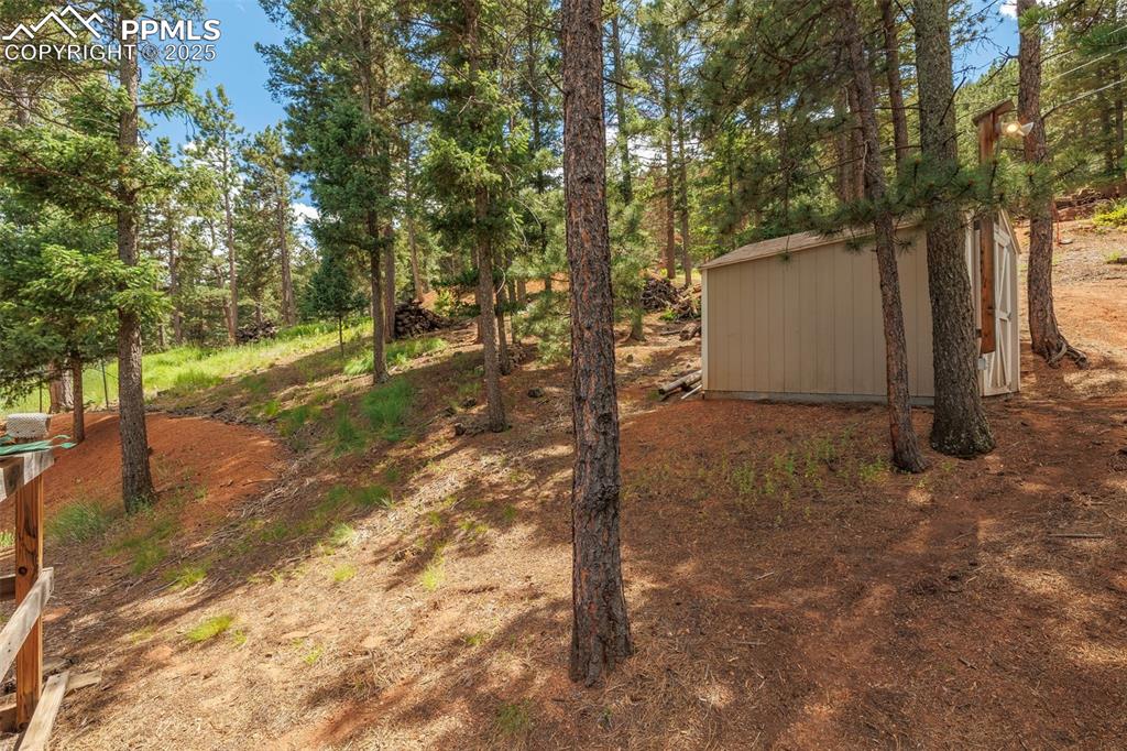 Image 27 of 32: View of yard with a storage unit