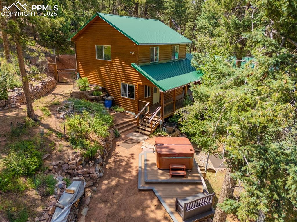 Image 31 of 32: Rear view of property with a hot tub