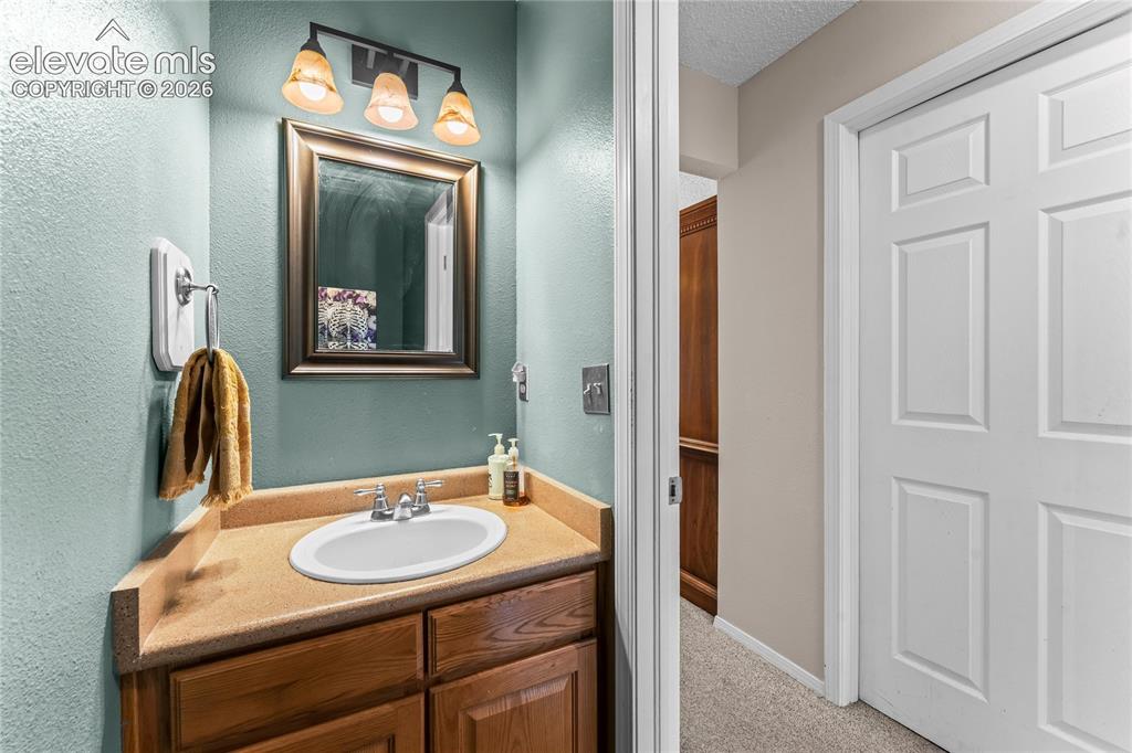 Image 16 of 45: main level powder room