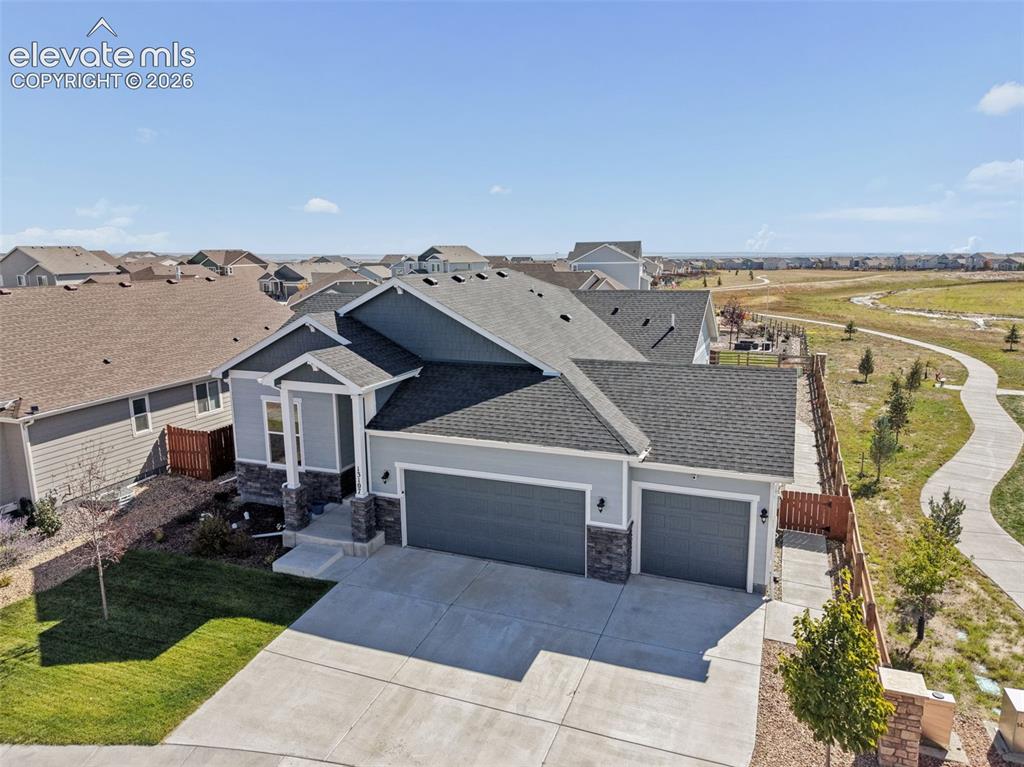 Image 1 of 40: Multi-gabled exterior featuring horizontal siding and stone veneer accents,