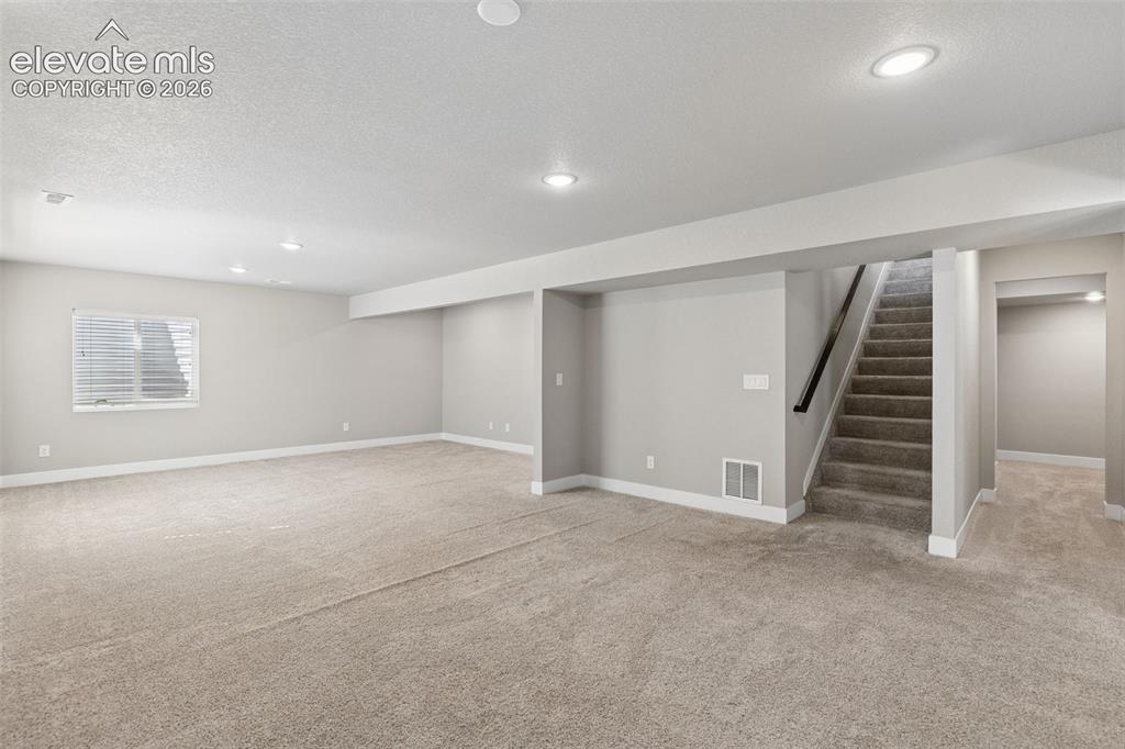 Image 20 of 40: Open floor plan featuring neutral wall tones, wall-to-wall carpeting, reces
