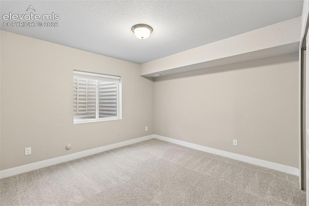 Image 25 of 40: Interior room featuring neutral wall paint, carpeted flooring, a recessed w
