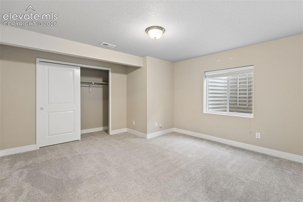 Image 26 of 40: Interior space featuring neutral wall tones, wall-to-wall carpeting, an egr