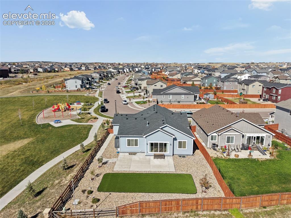 Image 36 of 40: Aerial perspective of a single-story residence featuring a concrete patio, 