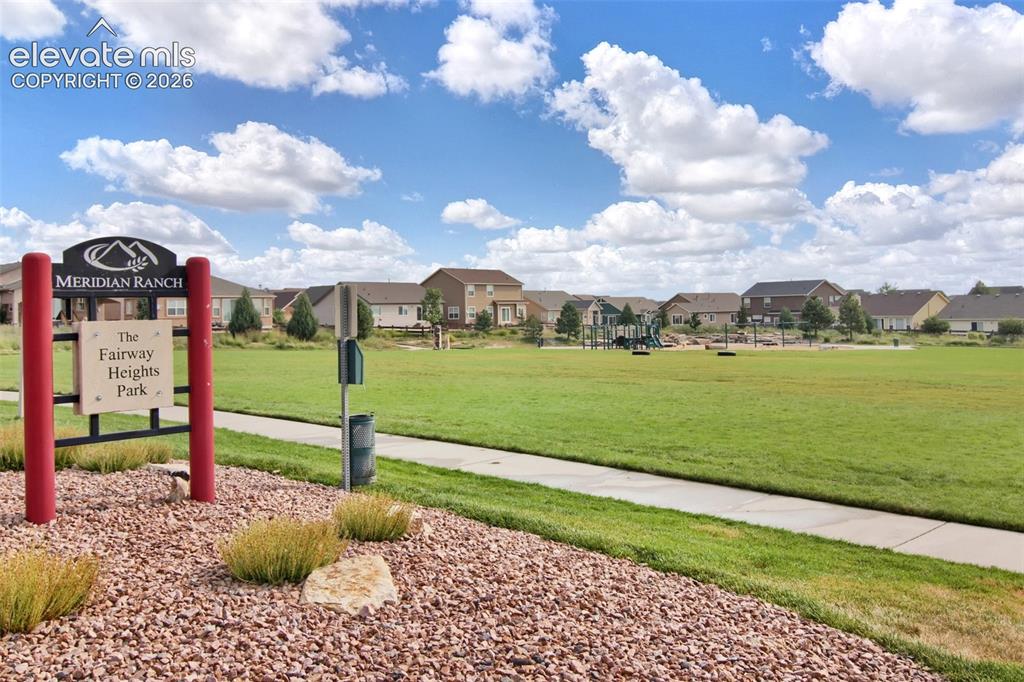 Image 40 of 40: Fairway Heights Park featuring a manicured grass field, concrete walking pa