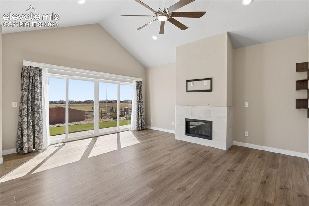 Image 5 of 40: Vaulted ceilings, wood-finish flooring, floor-to-ceiling glass sliding door