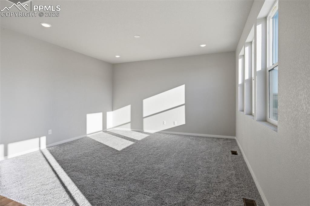Image 13 of 48: Carpeted spare room with recessed lighting