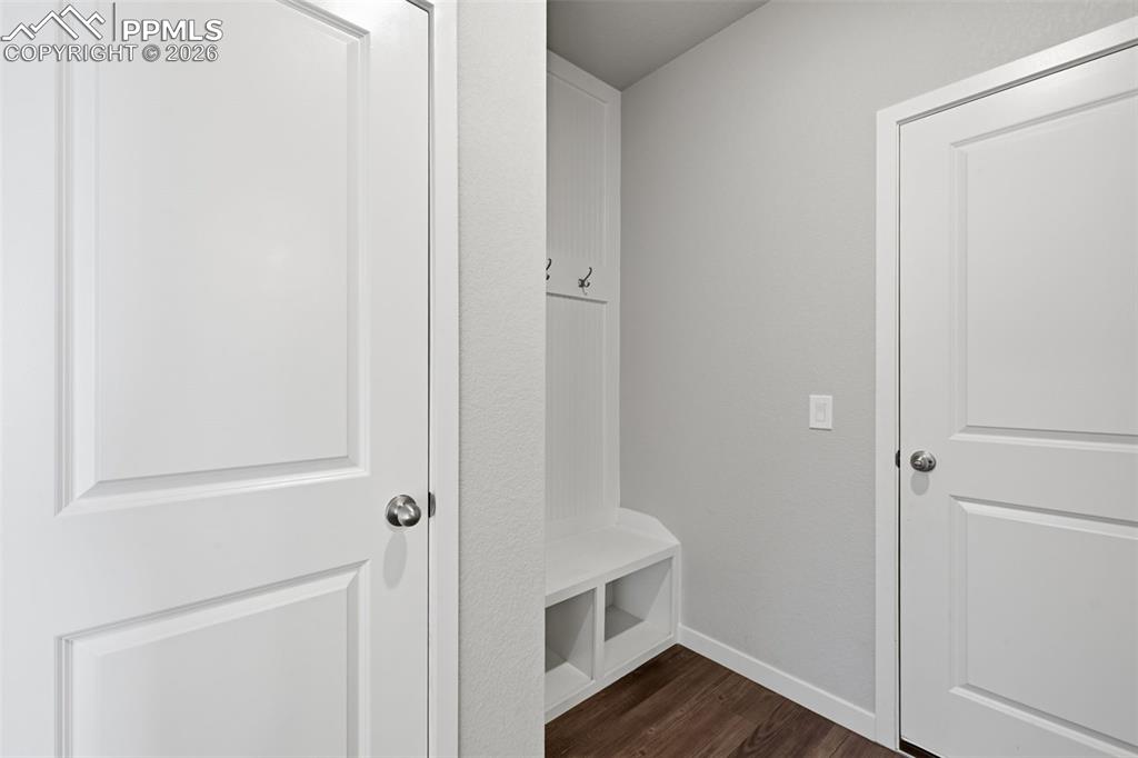 Image 14 of 48: Mudroom with dark wood-style floors and baseboards