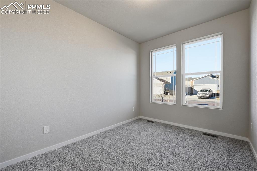 Image 16 of 48: Unfurnished room with carpet and baseboards