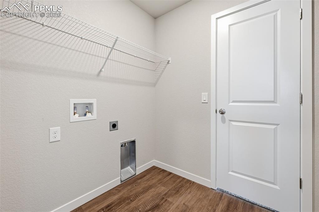 Image 36 of 48: Laundry room with hookup for an electric dryer, dark wood-type flooring, wa