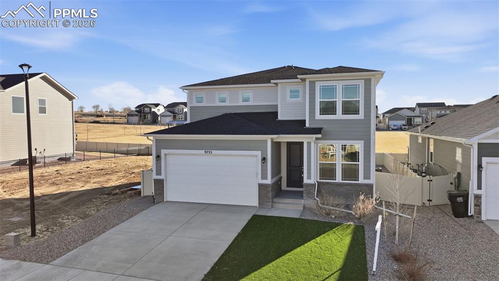 Image 38 of 48: View of front of home featuring a gate, concrete driveway, a residential vi