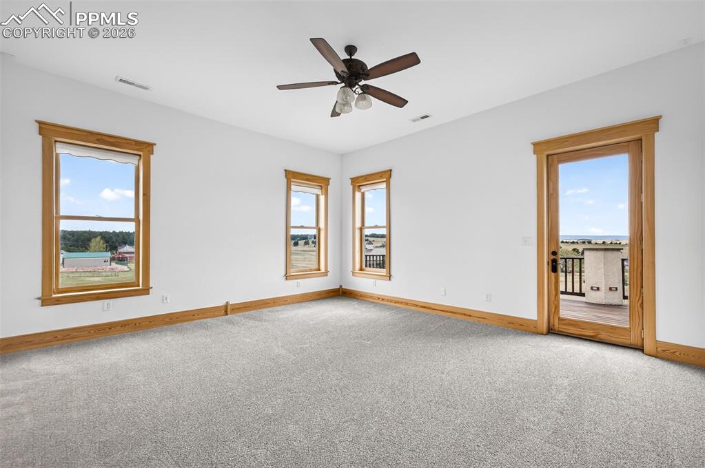 Image 17 of 50: Primary bedroom with deck access and incredible views