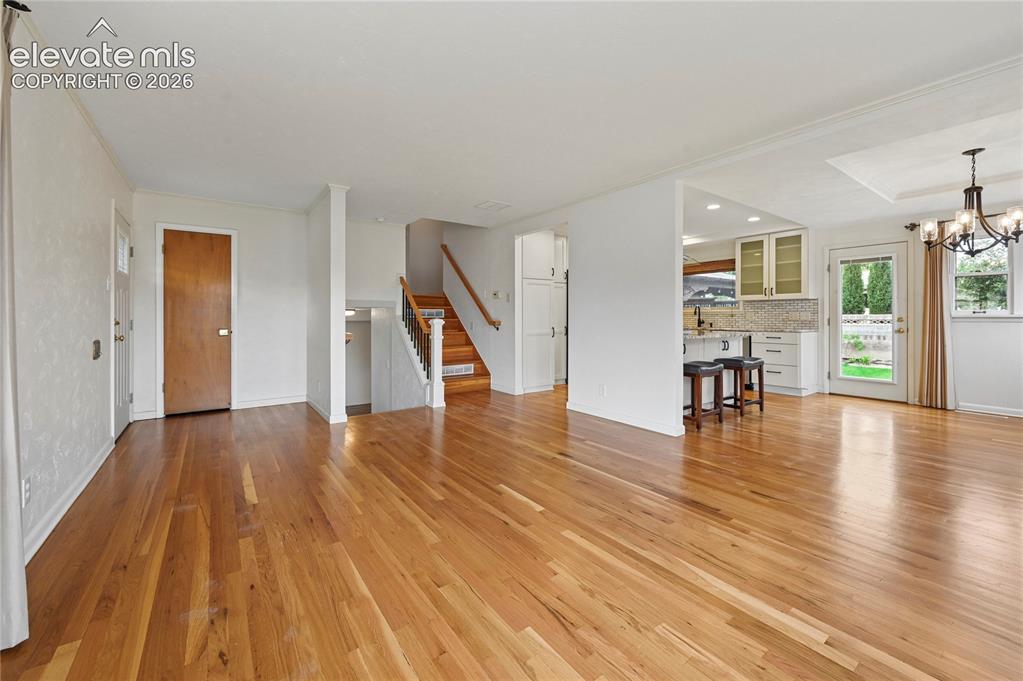 Image 10 of 50: Living Room (Looking Towards Entry, Stairs and Kitchen & Dining Room)