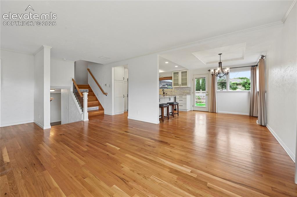 Image 11 of 50: Living Room (Looking Towards Entry, Stairs and Kitchen & Dining Room)