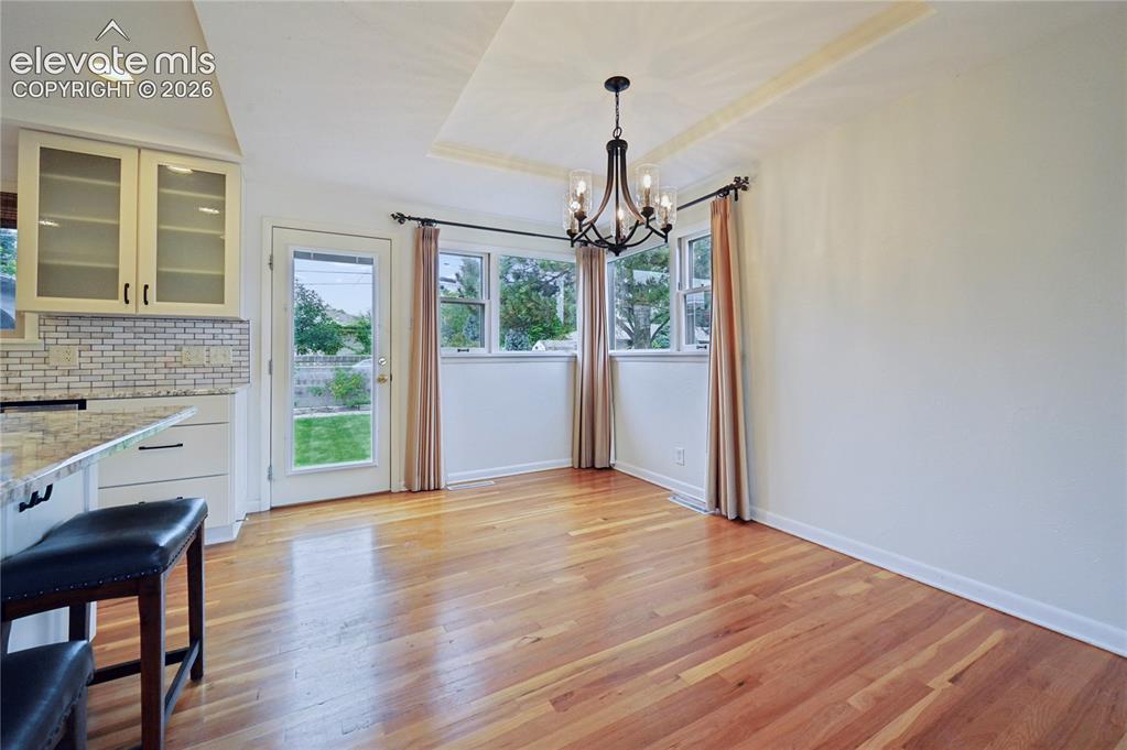 Image 13 of 50: Dining Room with Walk-Out to Backyard