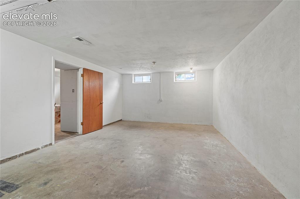 Image 38 of 50: Basement Family Room (Looking Towards Basement Bedroom & Bathroom)